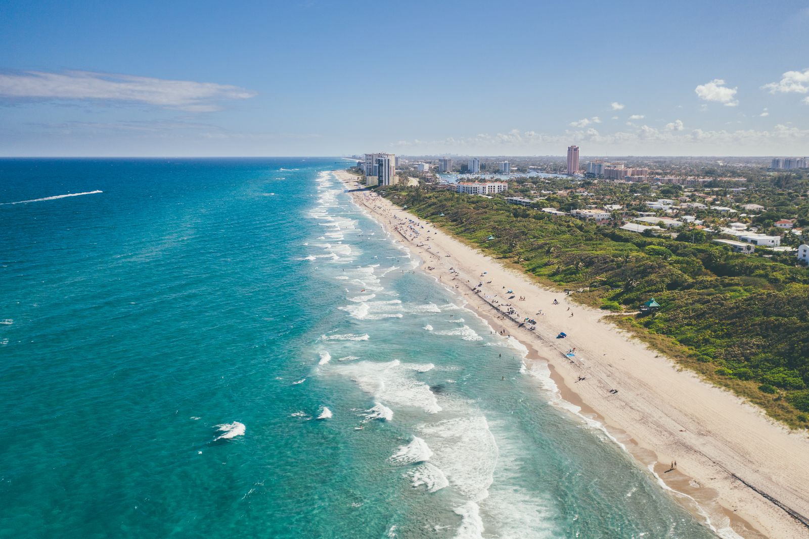A long South Florida coastline of beach, surf and condos curving into the distance