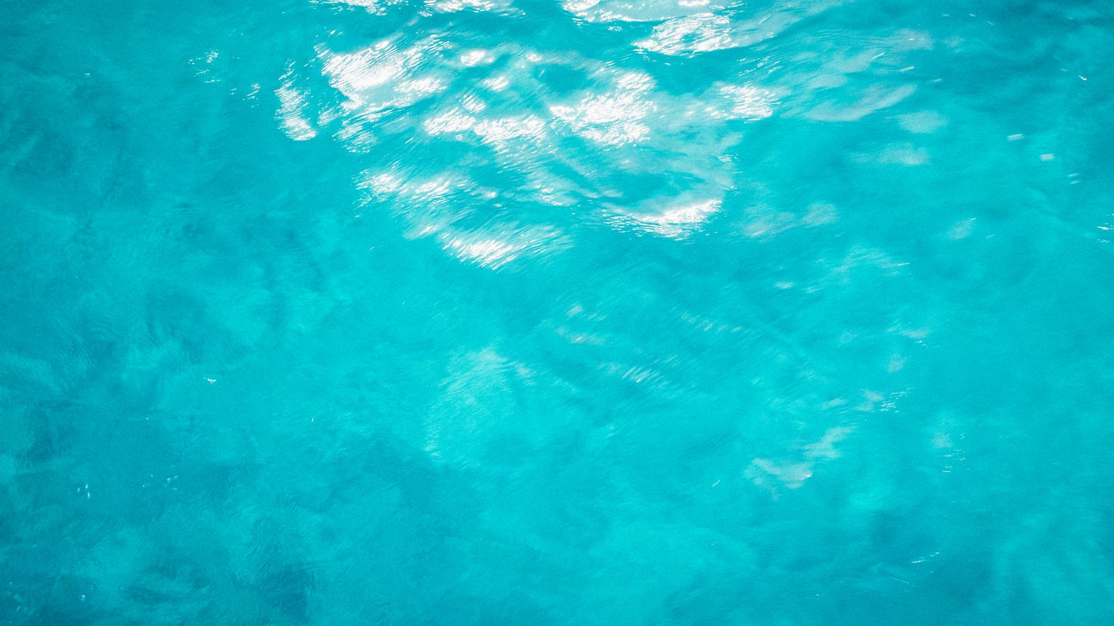 Rippled bright turquoise water from just above the surface